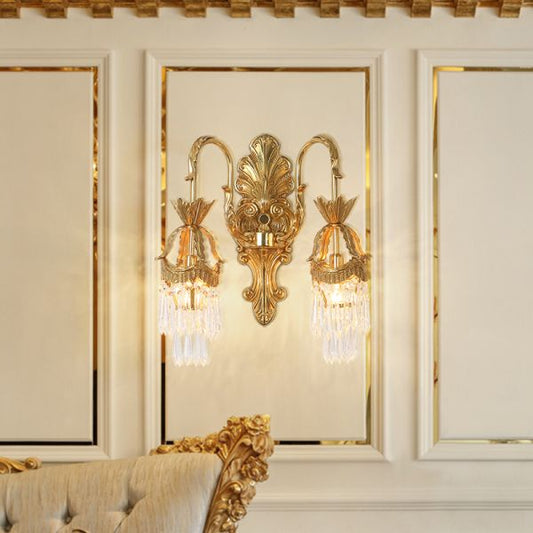 The French luxury wall lamp installed on a light wall with white trim and gold accents, emitting a soft glow.