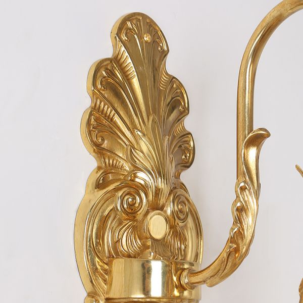 The installed wall sconce creating elegant light patterns in a sophisticated interior setting.