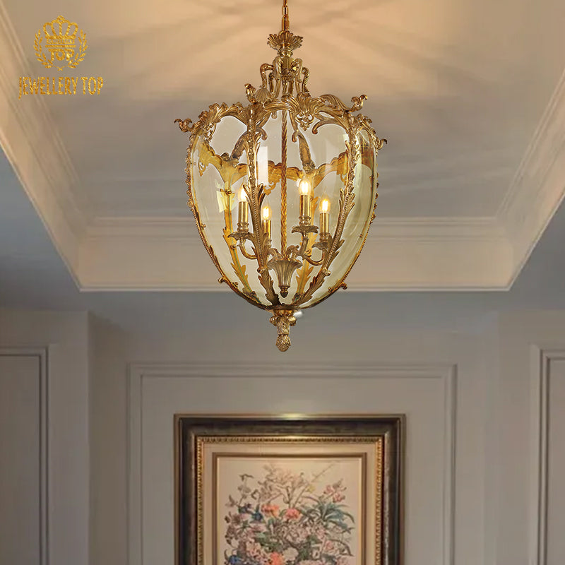JEWELLERY TOP antique brass pendant light installed above a floral painting on a light wall.
