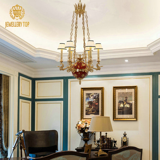 The classical brass chandelier installed in a study with a dark wood desk and blue walls.