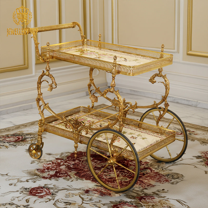 Full angled view of The Dionysus brass tea cart on a classic carpeted floor by Jewellery Top.