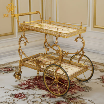 Full angled view of The Dionysus brass tea cart on a classic carpeted floor by Jewellery Top.