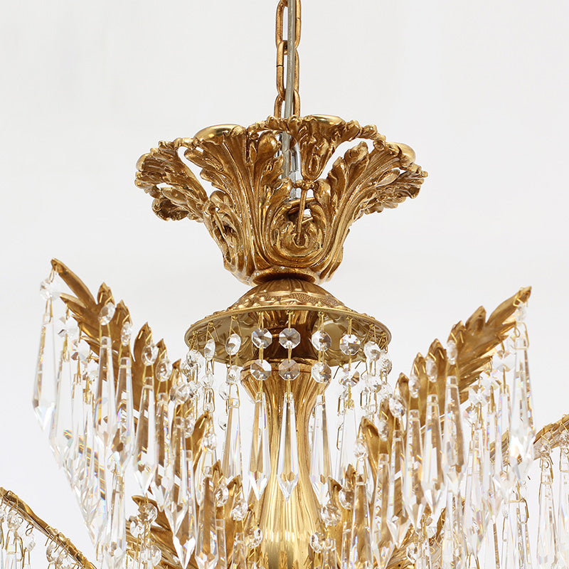 Detailed macro shot of ornate brass floral engraving and hanging teardrop crystal strings.