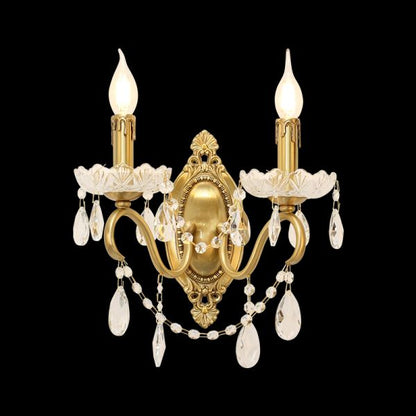 Product shot of the golden Jade Lumière brass double sconce with crystal chains on a black background.