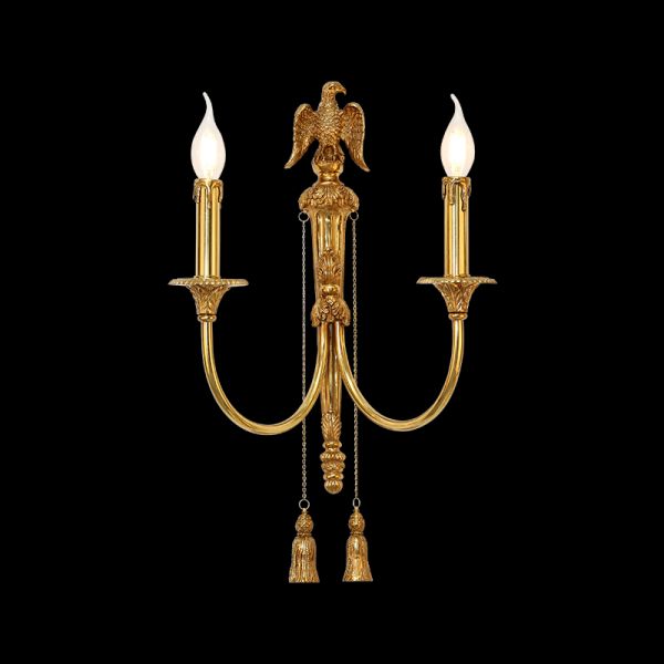 Close-up front view of the Aigle Impérial brass wall sconce with a detailed eagle sculpture and crystal fringes on black background, JEWELLERY TOP.