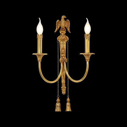 Close-up front view of the Aigle Impérial brass wall sconce with a detailed eagle sculpture and crystal fringes on black background, JEWELLERY TOP.