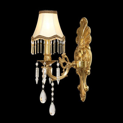 The French-style fabric lampshade wall light installed on an elegant white and gold-accented wall.