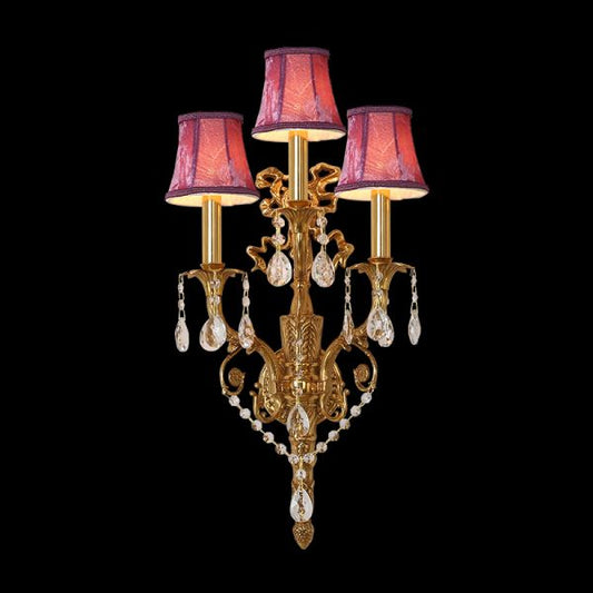 Front view of the Belle Époque Trio brass wall sconce with three pink fabric shades and crystal drops.