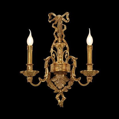 Front close-up of the Versailles Noeud Doré brass wall sconce with a central bow and two candle lights.