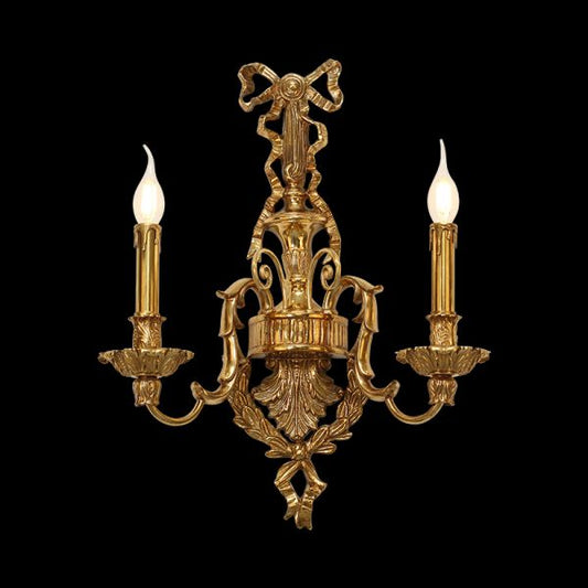 Front close-up of the Versailles Noeud Doré brass wall sconce with a central bow and two candle lights.