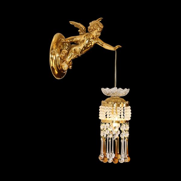 Close-up front view of the golden Cupid brass wall sconce with crystal drops on a black background.