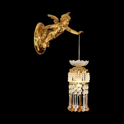 Close-up front view of the golden Cupid brass wall sconce with crystal drops on a black background.
