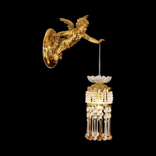Close-up front view of the golden Cupid brass wall sconce with crystal drops on a black background.