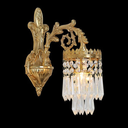 Close-up focusing on the cascading strands of clear crystal prisms and the illuminated bulb of the decorative wall light.