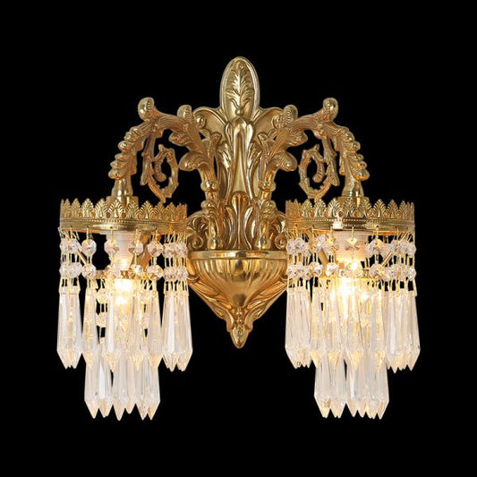 Front view of the golden Regal Crown brass wall sconce with crystal fringes, isolated on a black background.
