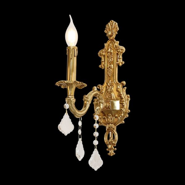 Close-up side view of the decorative brass wall lamp highlighting its ornate arm and crystals.