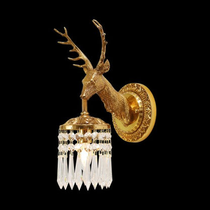 JEWELLERY TOP Stag Majesty Brass Wall Sconce with a golden deer head and crystal droplets on a black background.