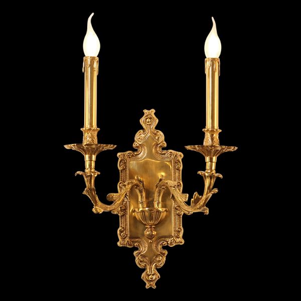 Detailed side angle of the French wall sconce showcasing its ornate brass scrollwork and glowing candle bulbs.