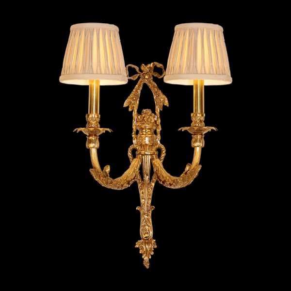 Front view of the Rococo Bow & Bough brass wall sconce with a central bow and two fabric shades on a dark background.