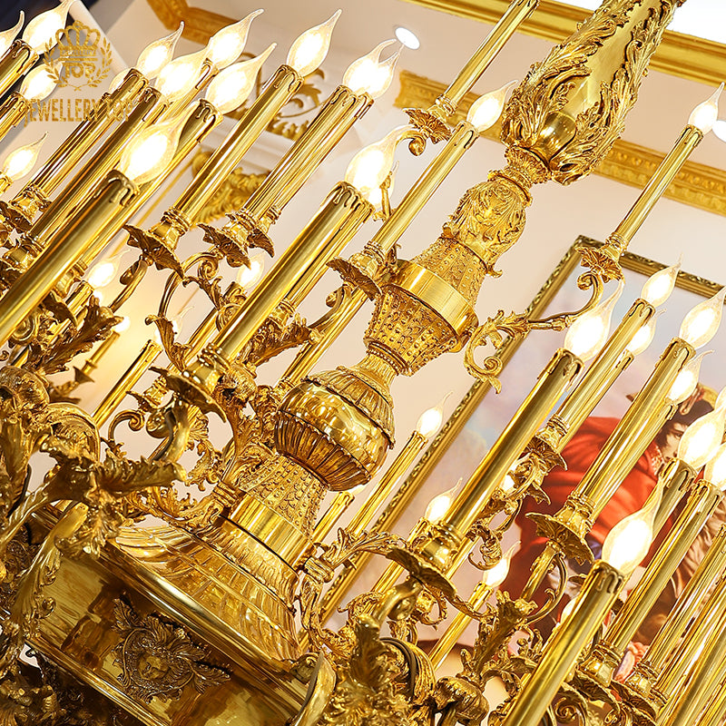 Close-up detail of exquisite Rococo-style scrolls and shell carvings on a brass chandelier frame.