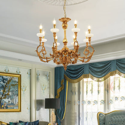 Classical brass chandelier installed in an elegant living room with patterned wallpaper and decor.