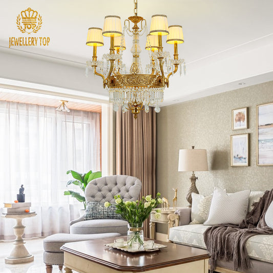 A luxury decorative chandelier installed in an elegant living room with French paneling and soft drapery.