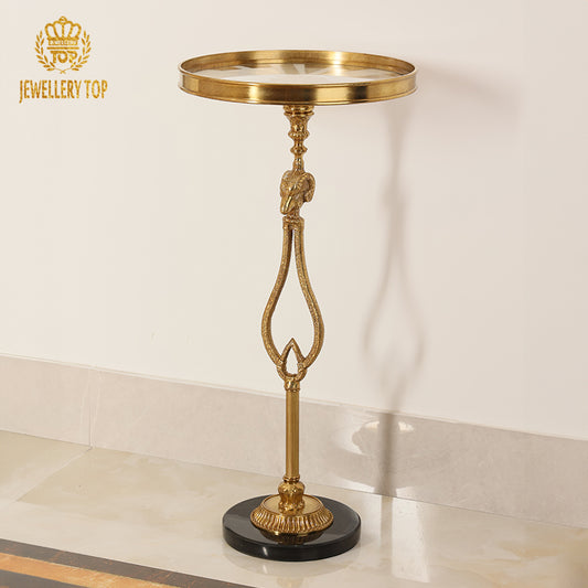 Full studio view of The Chrysomallos Neoclassical brass ram head side table with black marble base by Jewellery Top.