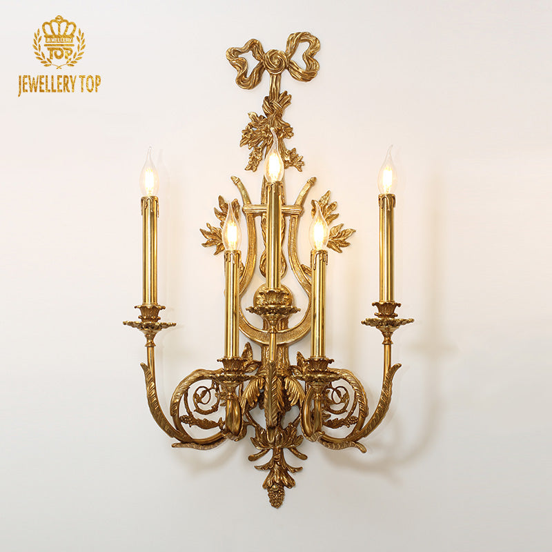 JEWELLERY TOP Rococo Bow Brass Wall Sconce with four candle bulbs and ornate bow decoration on a white background.