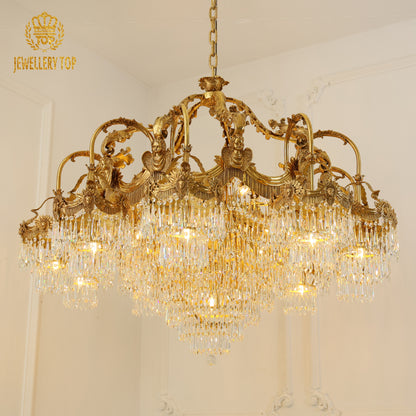 Extreme close-up of ornate brass cherub and floral carvings on a luxury chandelier.