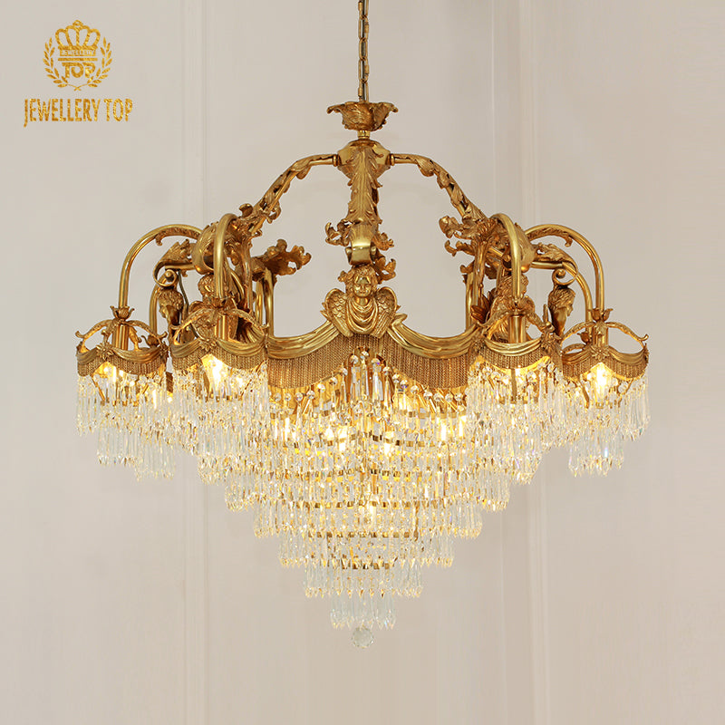 JEWELLERY TOP brand's golden classical chandelier against a white wall.