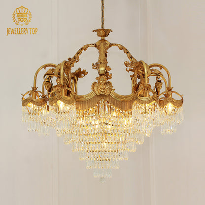 JEWELLERY TOP brand's golden classical chandelier against a white wall.