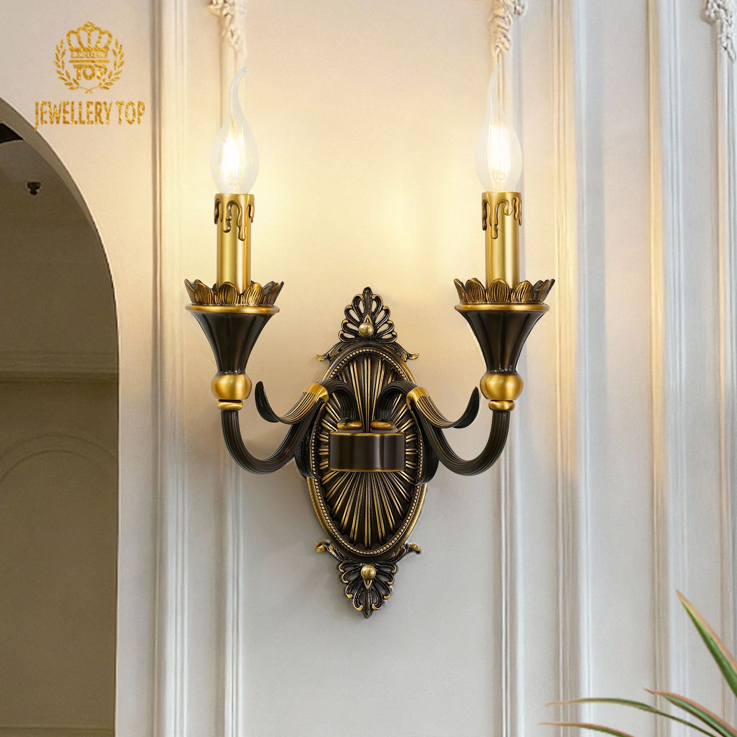 The French brass wall lamp with a dark central medallion and golden arms, installed beside an arched doorway.