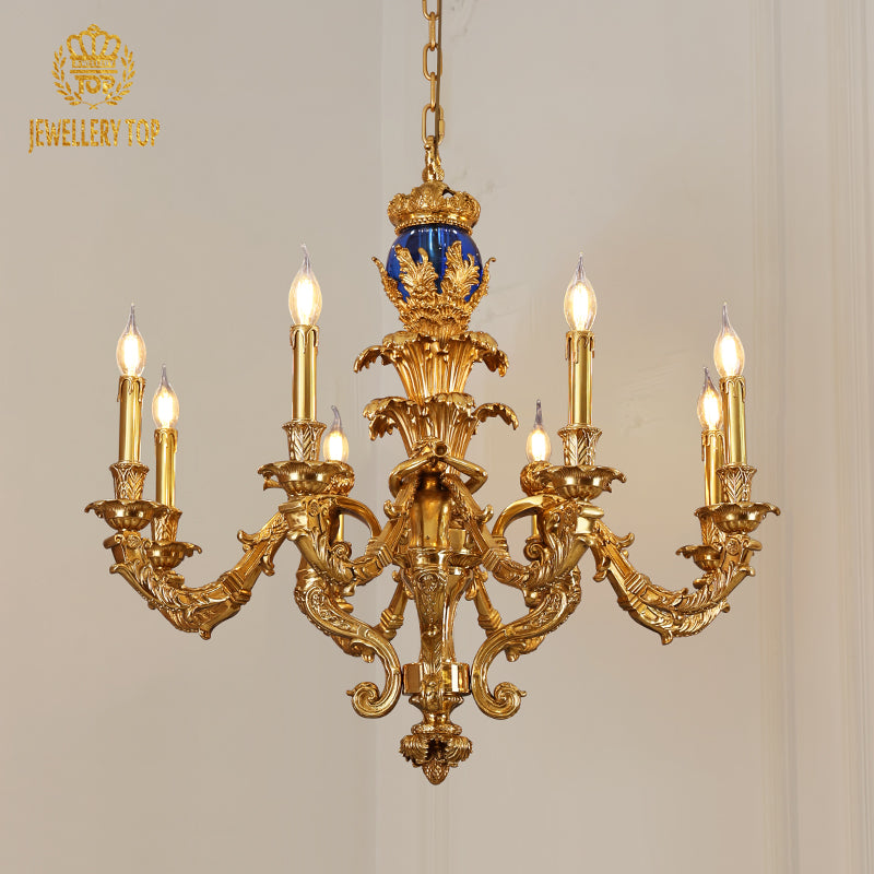 Front view of Cupid’s Serenade brass chandelier with blue finial and candle bulbs from JEWELLERY TOP.