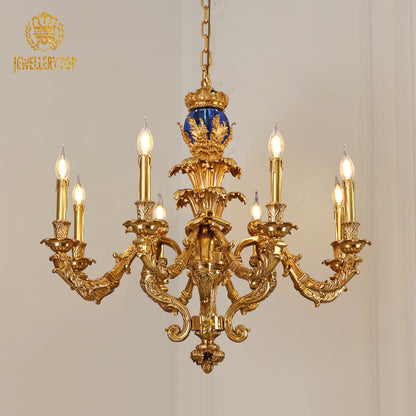 Front view of Cupid’s Serenade brass chandelier with blue finial and candle bulbs from JEWELLERY TOP.