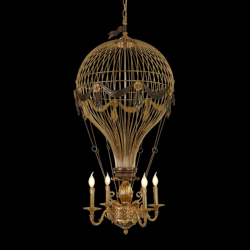 Close-up of Verne's Voyage hot-air balloon brass chandelier with CONCHERO detail, black background.