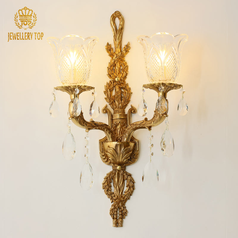 Front product view of the JEWELLERY TOP branded decorative wall sconce with two flower-shaped glass lampshades and lit bulbs.