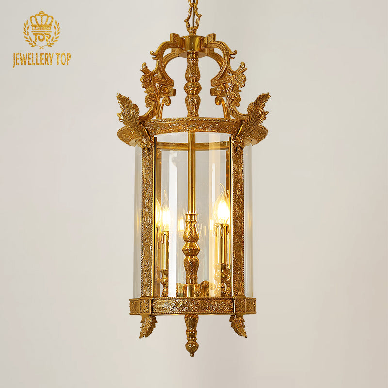 Élysée Palace Lanterne cylindrical brass pendant light with clear glass, on black background.