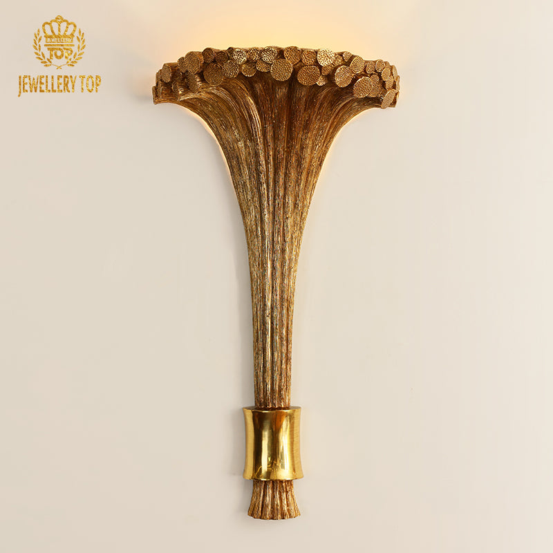 Front product view of the golden creative wall light with a flared trumpet shade and textured stem.