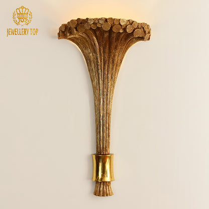 Front product view of the golden creative wall light with a flared trumpet shade and textured stem.