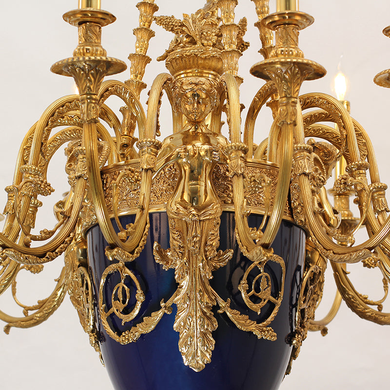 Extreme close-up of the allegorical female sculpture and cobalt blue urn on the chandelier.