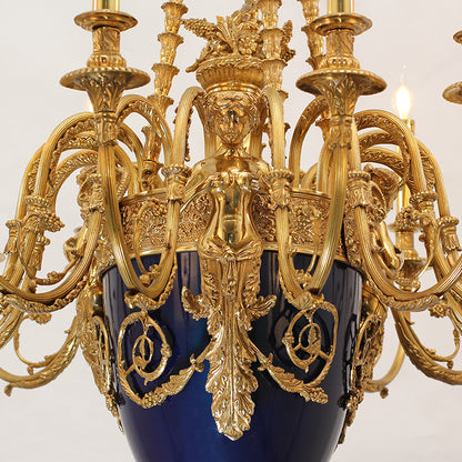 Extreme close-up of the allegorical female sculpture and cobalt blue urn on the chandelier.