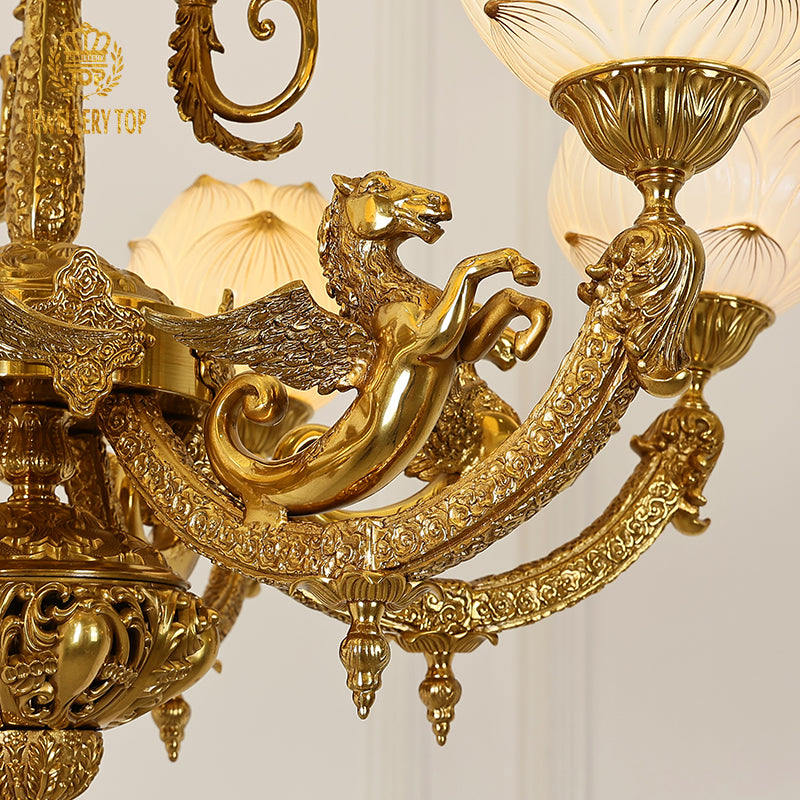 Macro close-up of the finely detailed golden winged horse motif and the textured brass acanthus leaves.