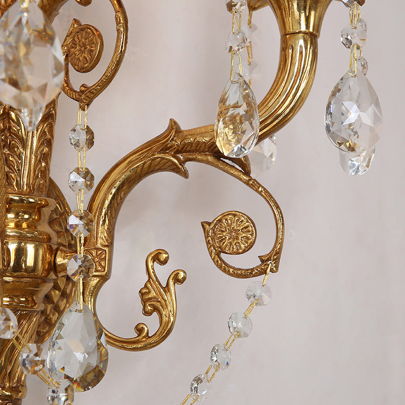 Detailed close-up of a single sparkling crystal pendant and the finely chased brass arm.