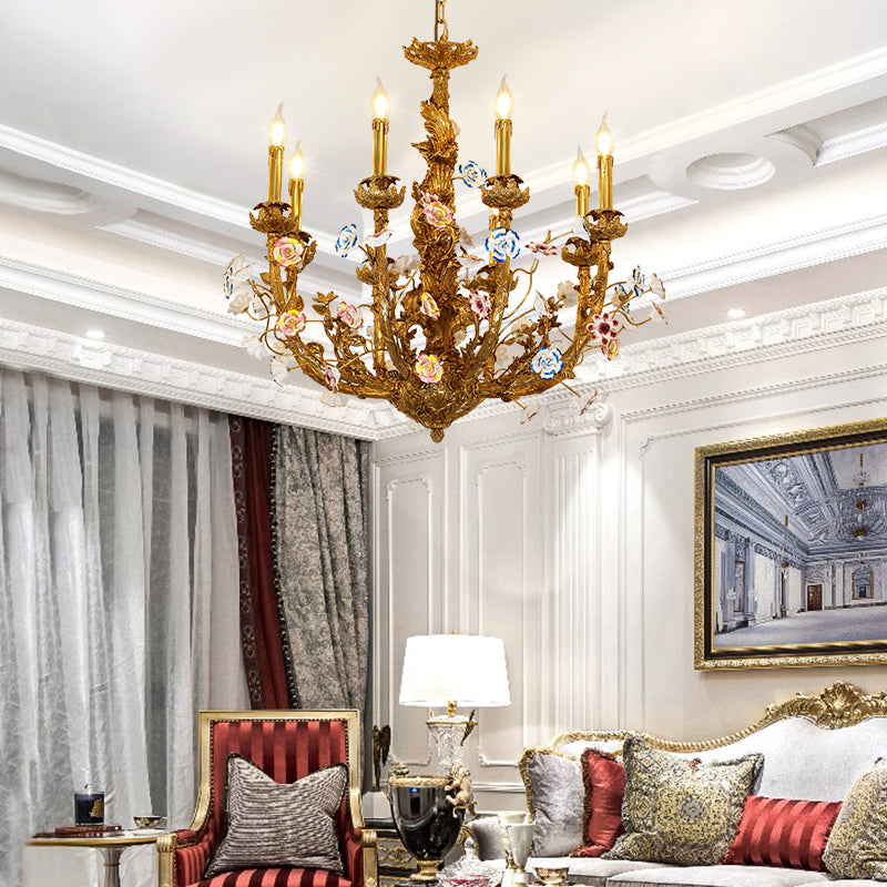The French ceramic brass chandelier installed in an elegant living room with a striped armchair.