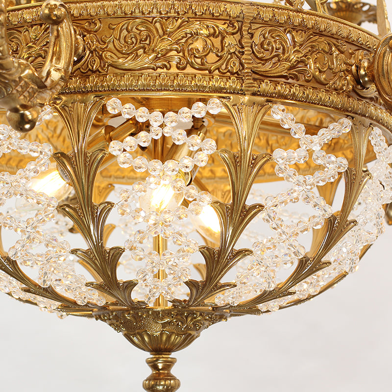 Extreme detail shot focusing on the candle-shaped filament bulbs and the decorative brass bobeche adorned with hanging crystals.