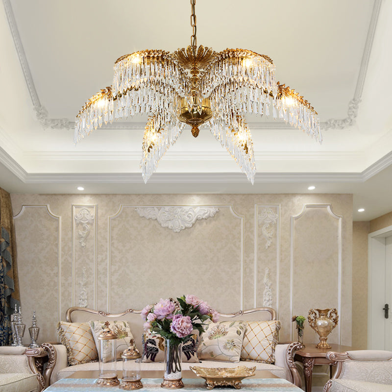 Luxury European brass chandelier with palm leaf motif installed in a modern classic living room.