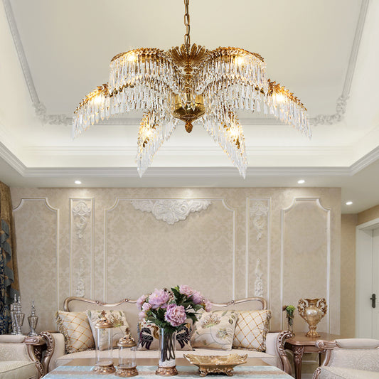Luxury European brass chandelier with palm leaf motif installed in a modern classic living room.