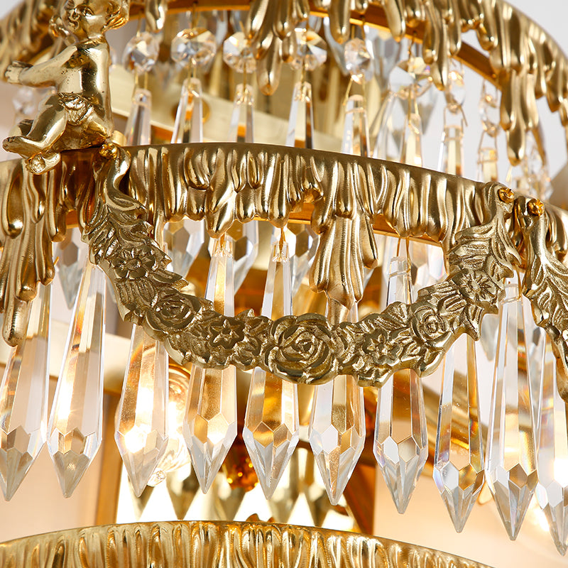 Extreme close-up of the sunburst or wheat-sheaf motif and layered crystal fringe of the villa living room lamp.