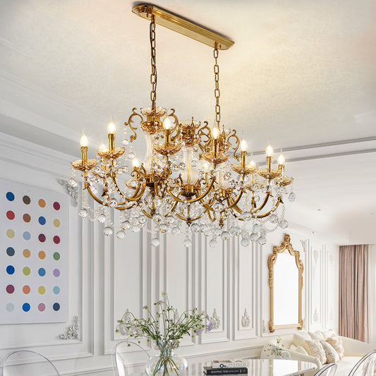 A french luxury chandelier installed in a spacious, high-ceilinged dining room with classic French wall paneling.