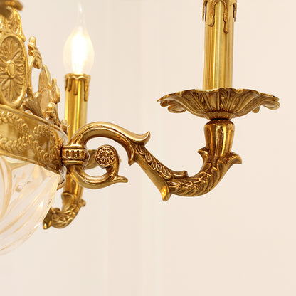 Close-up detail of a curved brass arm with intricate carvings, connecting to a crystal element.